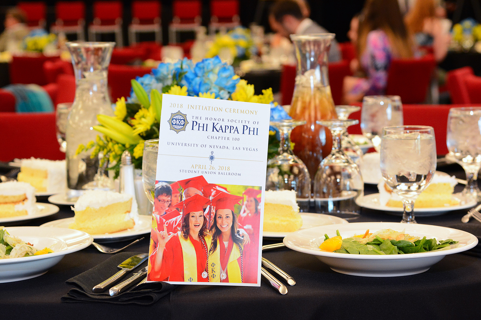 Banquet table featuring a Phi Kappa Phi program